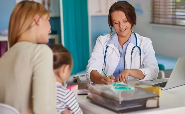 Pediatric Primary Care Nurse Practitioner Diagnosing Child Patient