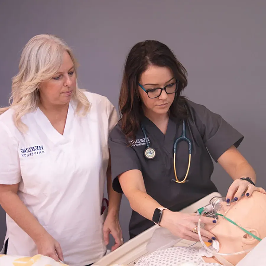 Accelerated Nursing Student Under Instruction in Laboratory Experience